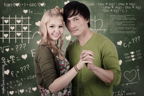 Photo: Romantic student couple in class Romantic student couple in class
