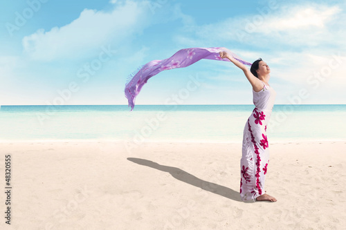 Photo: Woman enjoying holiday at beach Woman enjoying holiday at beach