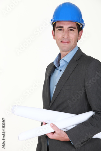 Photo: Architect holding rolled plan under arm Architect holding rolled plan under arm