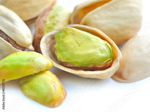 Photo: Pistachio nuts on white background Pistachio nuts on white background