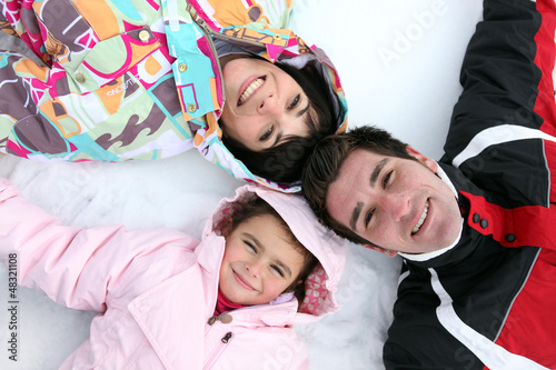 Photo: Family laying in the snow Family laying in the snow