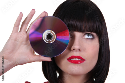 Photo: Woman holding CD Woman holding CD