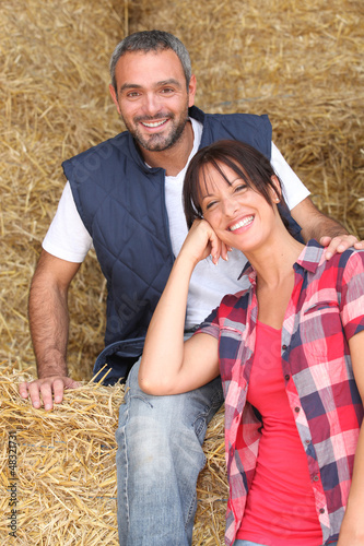 Photo: Farming couple sitting on hay Farming couple sitting on hay
