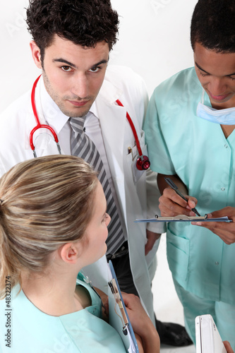 Photo: Three hospital staff members having discussion Three hospital staff members having discussion