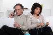 Man on phone and woman knitting at home