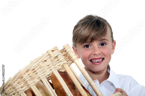 Photo: Young girl holding a bread basket Young girl holding a bread basket