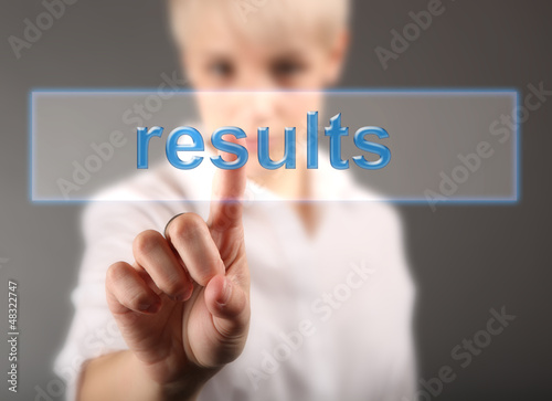 Photo: Results business concept - girl touching screen Results business concept - girl touching screen