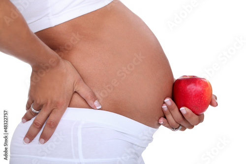 Photo: pregnant woman holding an apple pregnant woman holding an apple
