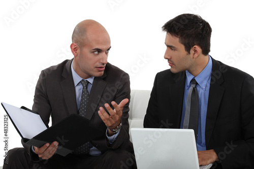 Photo: two business colleagues having a discussion two business colleagues having a discussion
