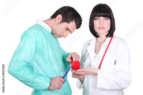 Photo: Doctors performing open heart surgery Doctors performing open heart surgery