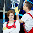 Two car mechanics store winter tires for tire changing