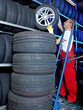 Car mechanics looking for a tire in a tire warehouse