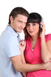 brunette with earphones and boyfriend cuddling