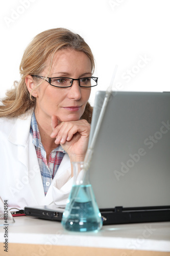 Photo: Chemist working at a laptop computer Chemist working at a laptop computer
