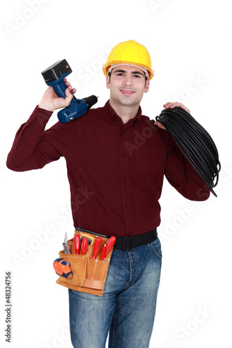 Photo: Electrician with a cordless drill Electrician with a cordless drill