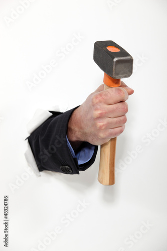 Photo: male hand holding hammer male hand holding hammer