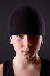 boy in a black T-shirt and a black hat
