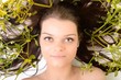Woman with bunch of mistletoe against white background
