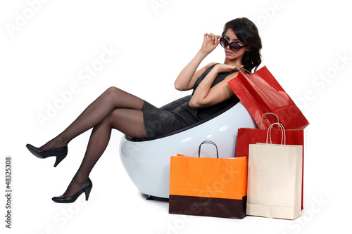 Photo: Glamorous woman surrounded by store bags Glamorous woman surrounded by store bags