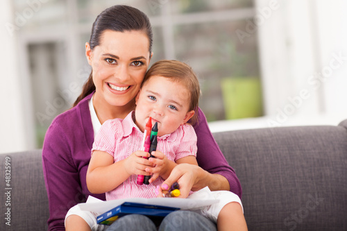 Photo: happy mother and little daughter with crayon at home happy mother and little daughter with crayon at home