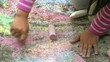 Child Painting with Colorful Chalk on the Pavement