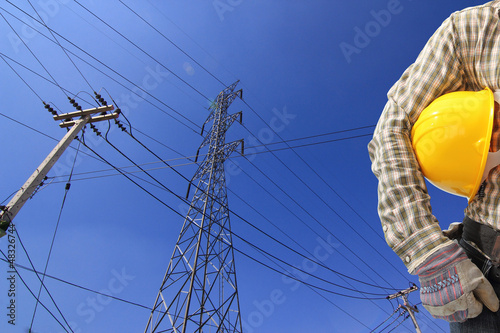 Photo: Electrician and high voltage power transmission line tower with Electrician and high voltage power transmission line tower with