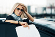 Young businesswoman with a car
