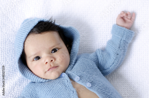 Photo: Newborn baby wearing blue cardigan Newborn baby wearing blue cardigan