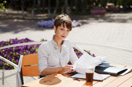 Photo: Young businesswoman at a sidewalk cafe Young businesswoman at a sidewalk cafe