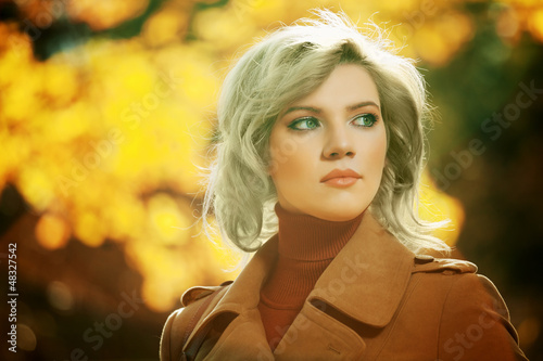 Photo: Young woman walking in autumn forest Young woman walking in autumn forest