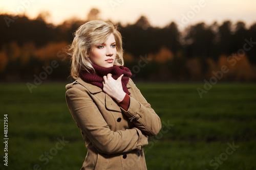 Photo: Young woman walking in autumn field Young woman walking in autumn field