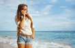 young woman with mobile phone on a beach, bali