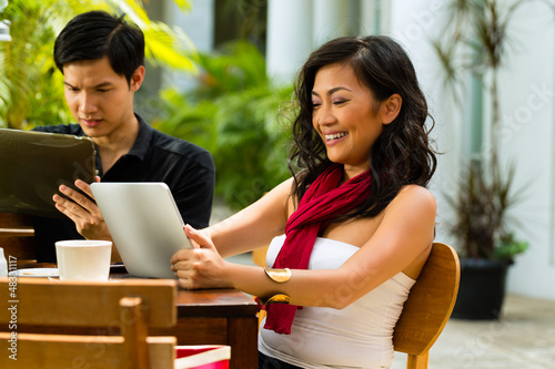 Photo: Asian people in cafe with computer Asian people in cafe with computer