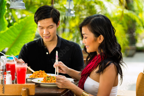 Photo: Asian man and woman in restaurant Asian man and woman in restaurant
