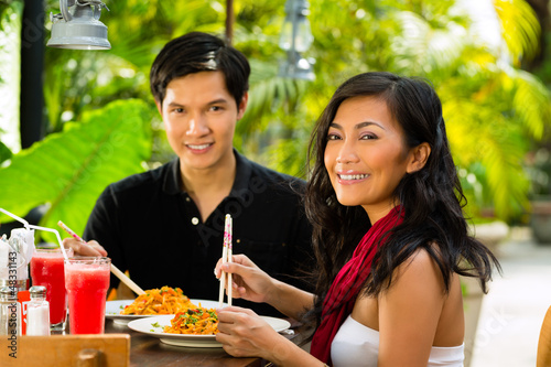 Photo: Asian man and woman in restaurant Asian man and woman in restaurant