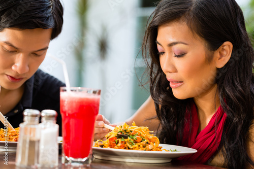 Photo: Asian man and woman in restaurant Asian man and woman in restaurant