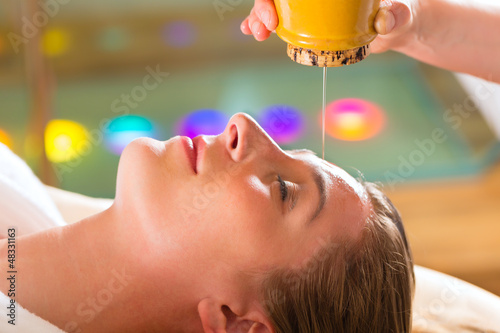 Photo: Woman enjoying a Ayurveda oil massage Woman enjoying a Ayurveda oil massage