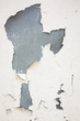 Old flaky white paint peeling off of a wall