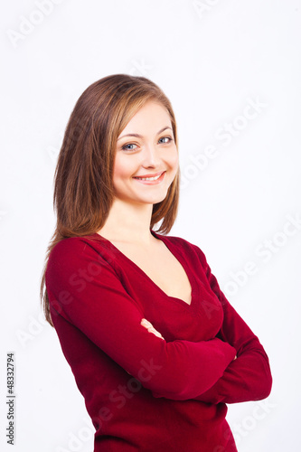 Photo: smiling woman with crossed arms isolated on white smiling woman with crossed arms isolated on white