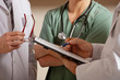 Doctor Standing With Colleagues