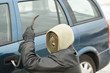 Robber with a crowbar near the car door