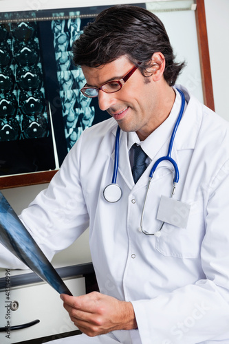 Photo: Male Radiologist Reviewing X-ray Male Radiologist Reviewing X-ray