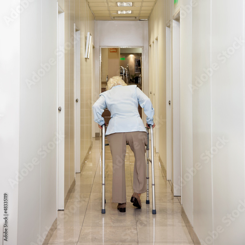 Photo: Woman With Walker In Corridor Woman With Walker In Corridor