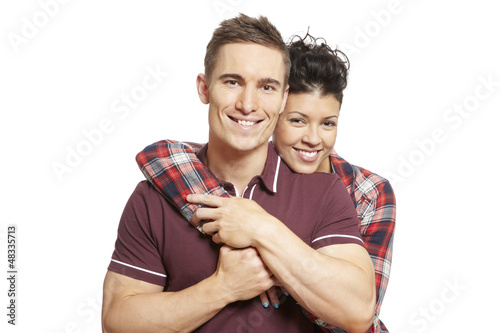 Photo: Young couple cuddling and smiling Young couple cuddling and smiling