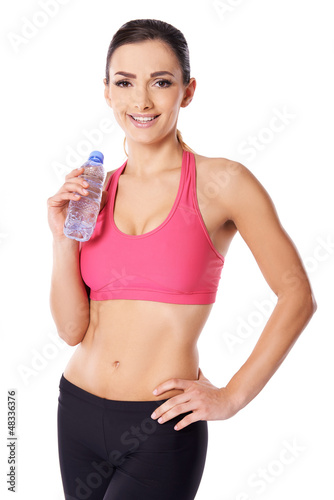 Photo: Beautiful female athlete drinking water Beautiful female athlete drinking water
