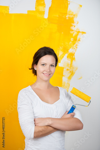 Photo: junge frau mit farbrolle junge frau mit farbrolle