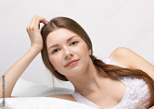 Photo: beautiful young woman in a bed beautiful young woman in a bed