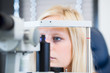 Pretty, young female patient having her eyes examined