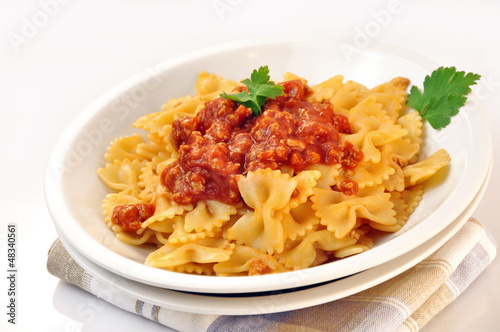 Photo: italian pasta - farfalle with meat and tomato sauce italian pasta - farfalle with meat and tomato sauce