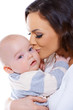 Loving mother kissing her small baby